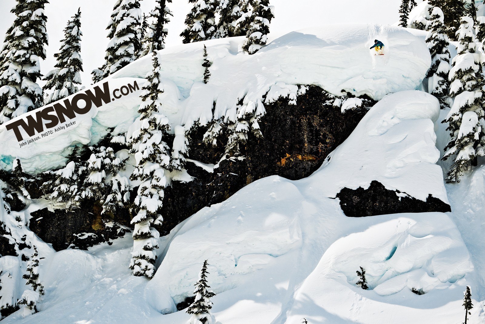 Snowboarder on a snowy cliff