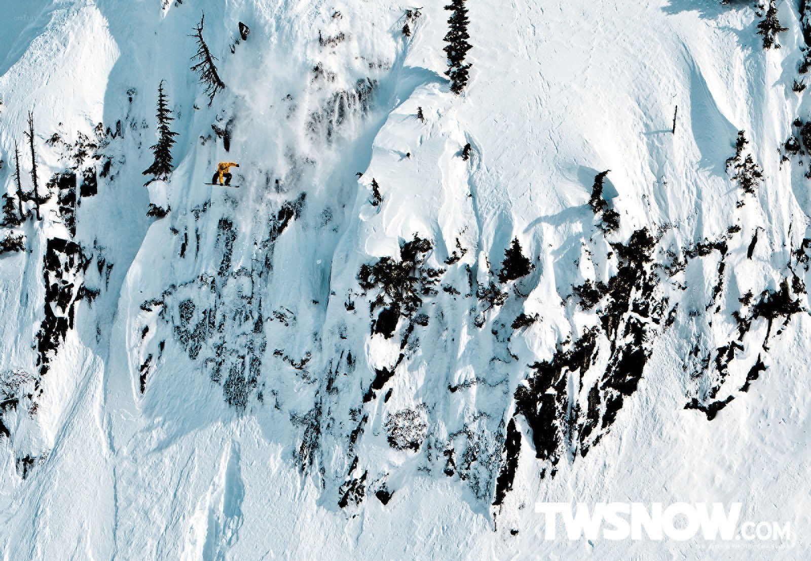 Snowboarder on a snowy cliff