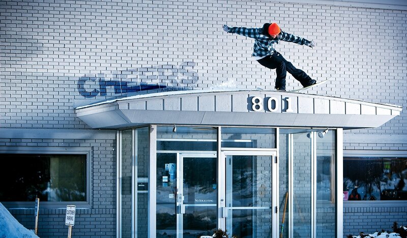 Snowboarder on building roof