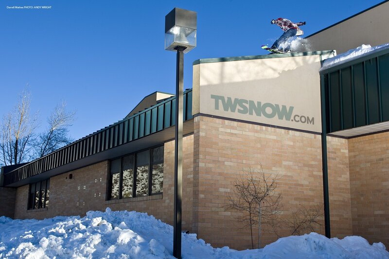Snowboarder on building roof