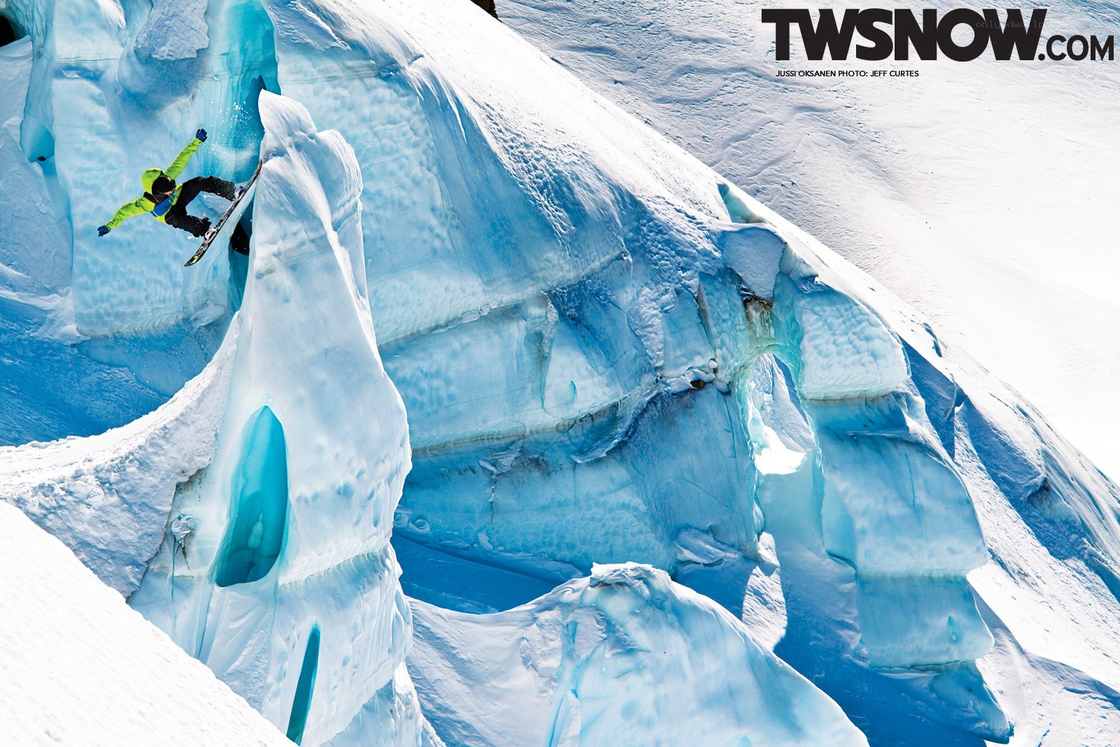 Snowboarder on icy cliff