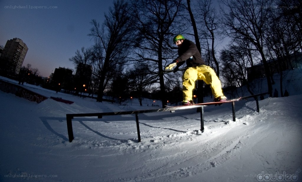 snowboarder on rail at dusk