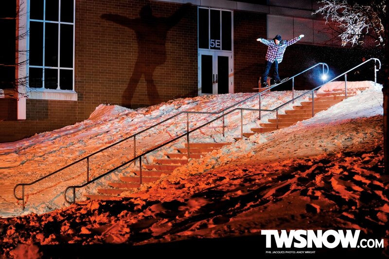 Snowboarder on rail at night