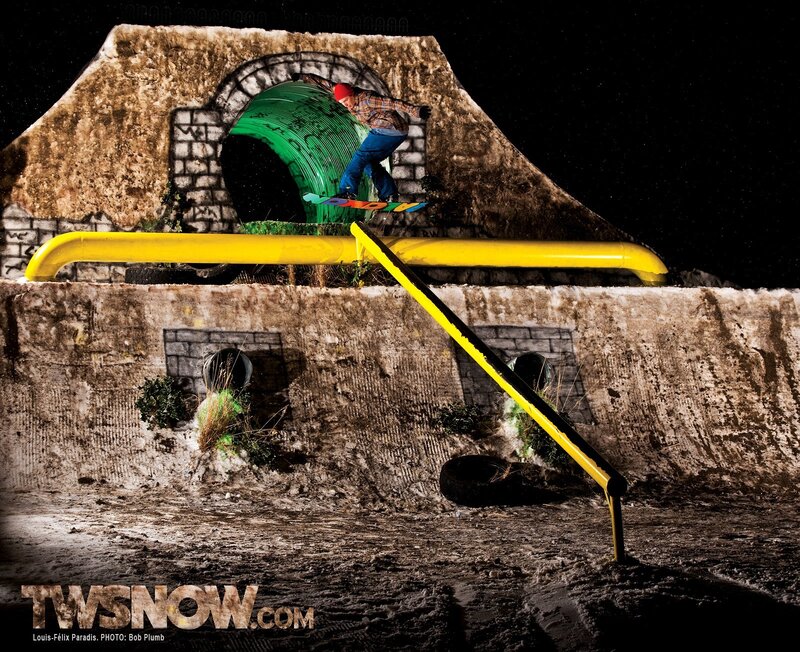 Snowboarder on rail at night