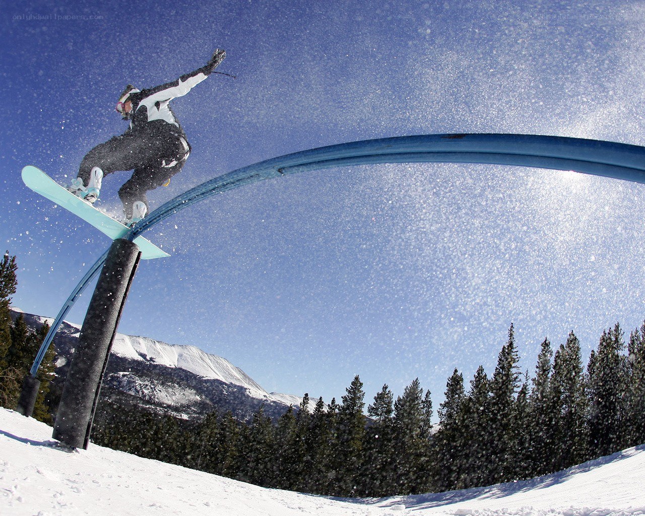 Snowboarder on rail feature