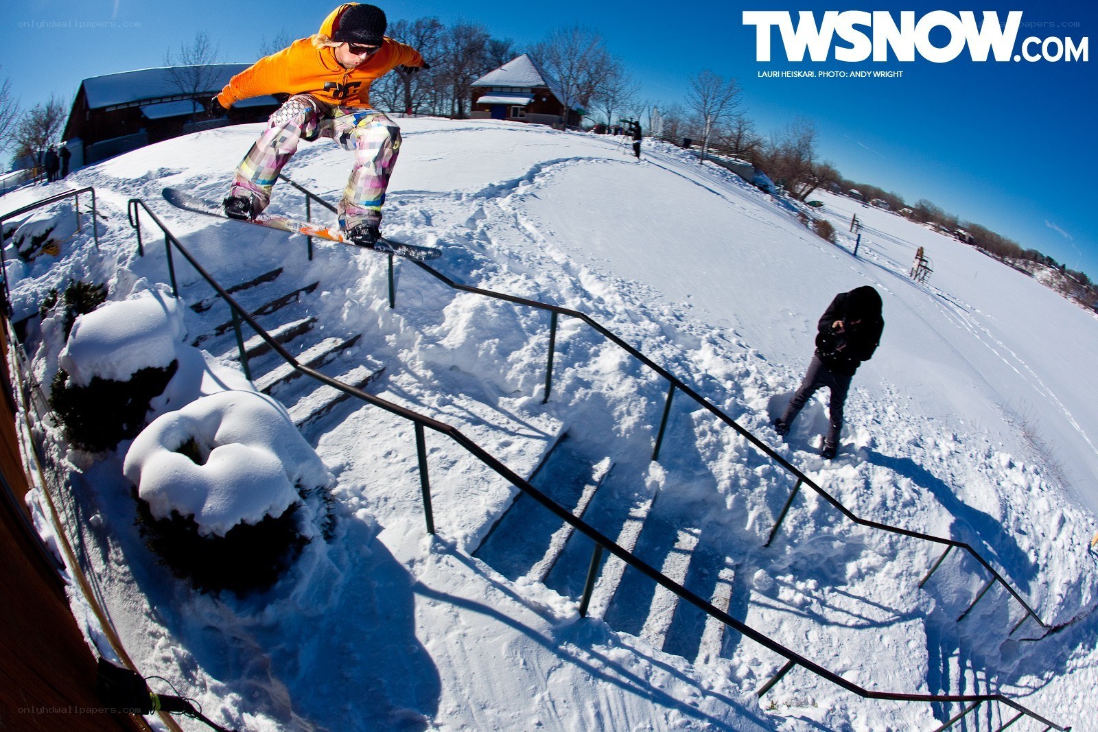 Snowboarder on rail in snow