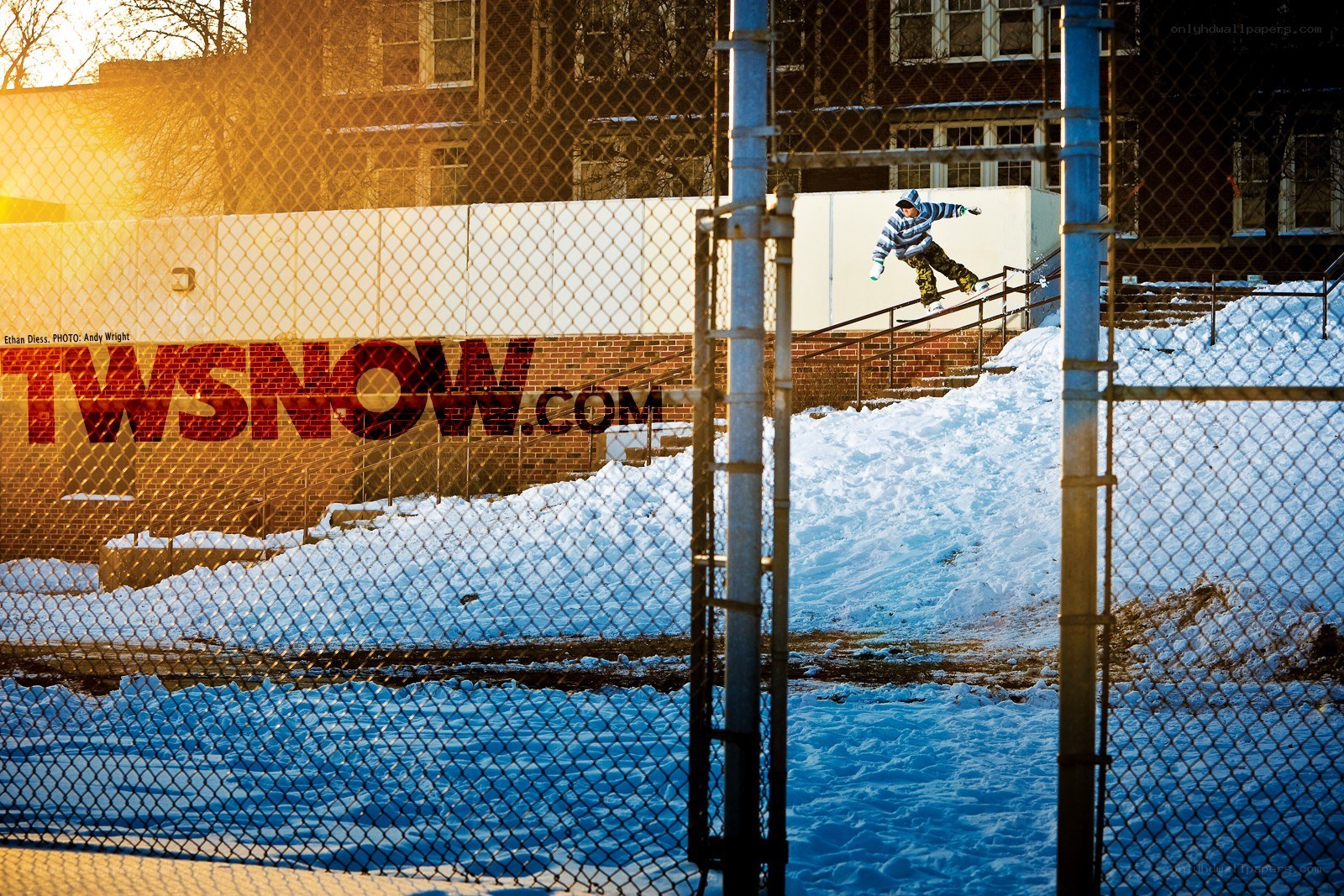Snowboarder on rail in snow