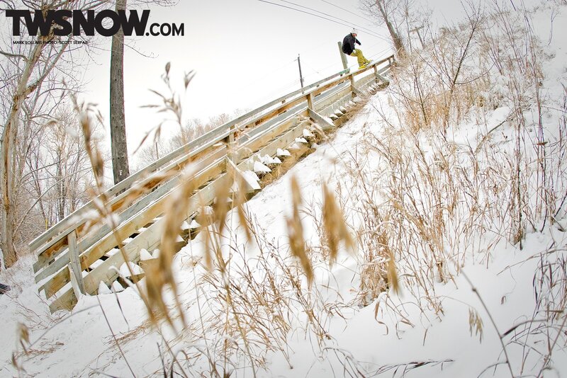 Snowboarder on wooden stairs