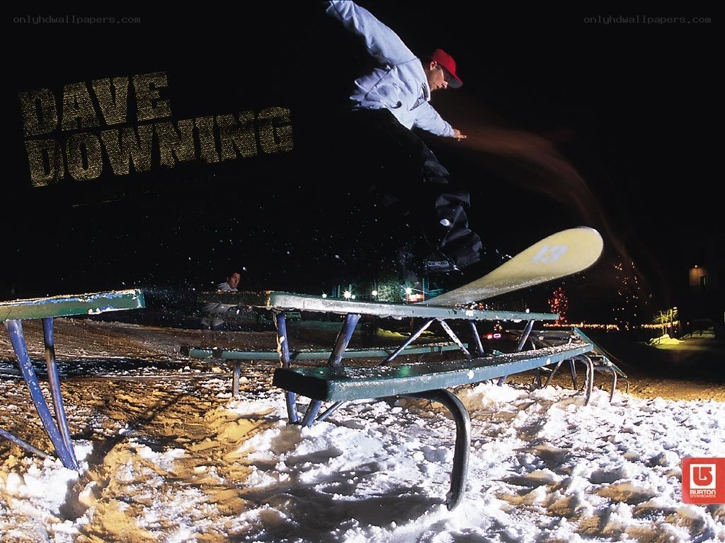Snowboarder performing trick at night