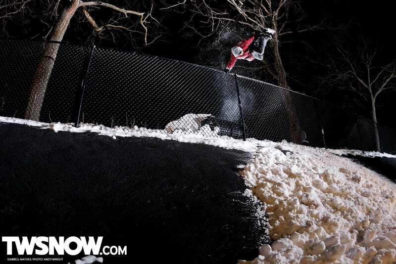 Snowboarder performing trick at night