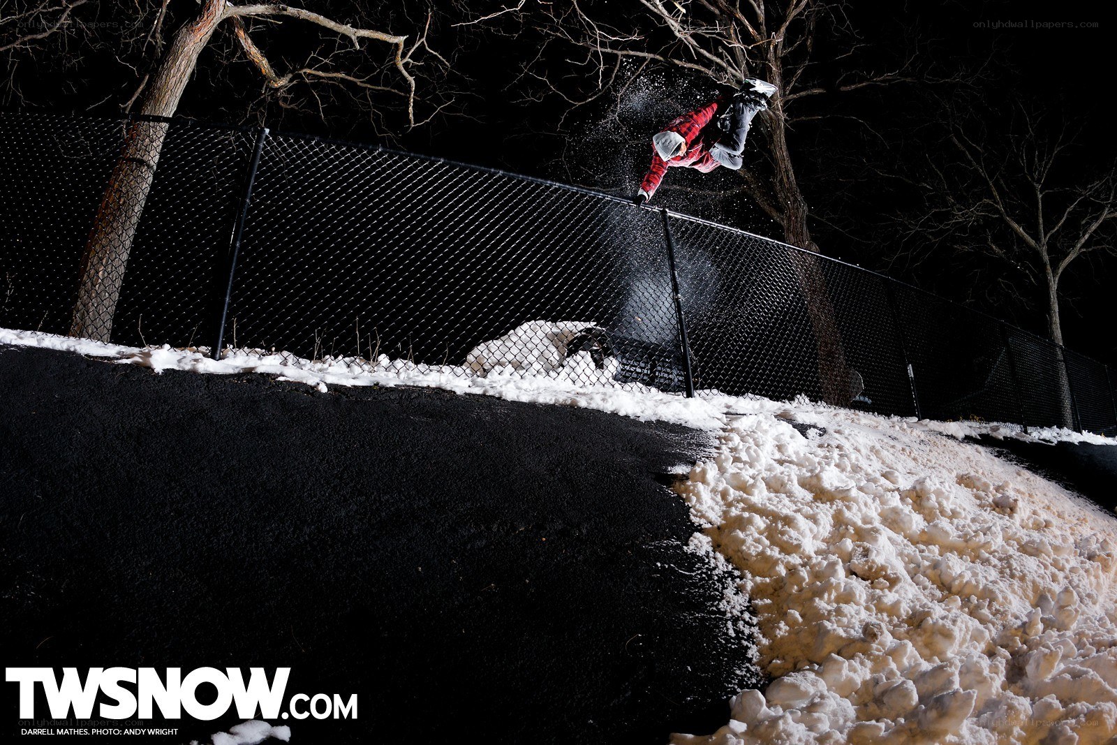 Snowboarder performing trick at night