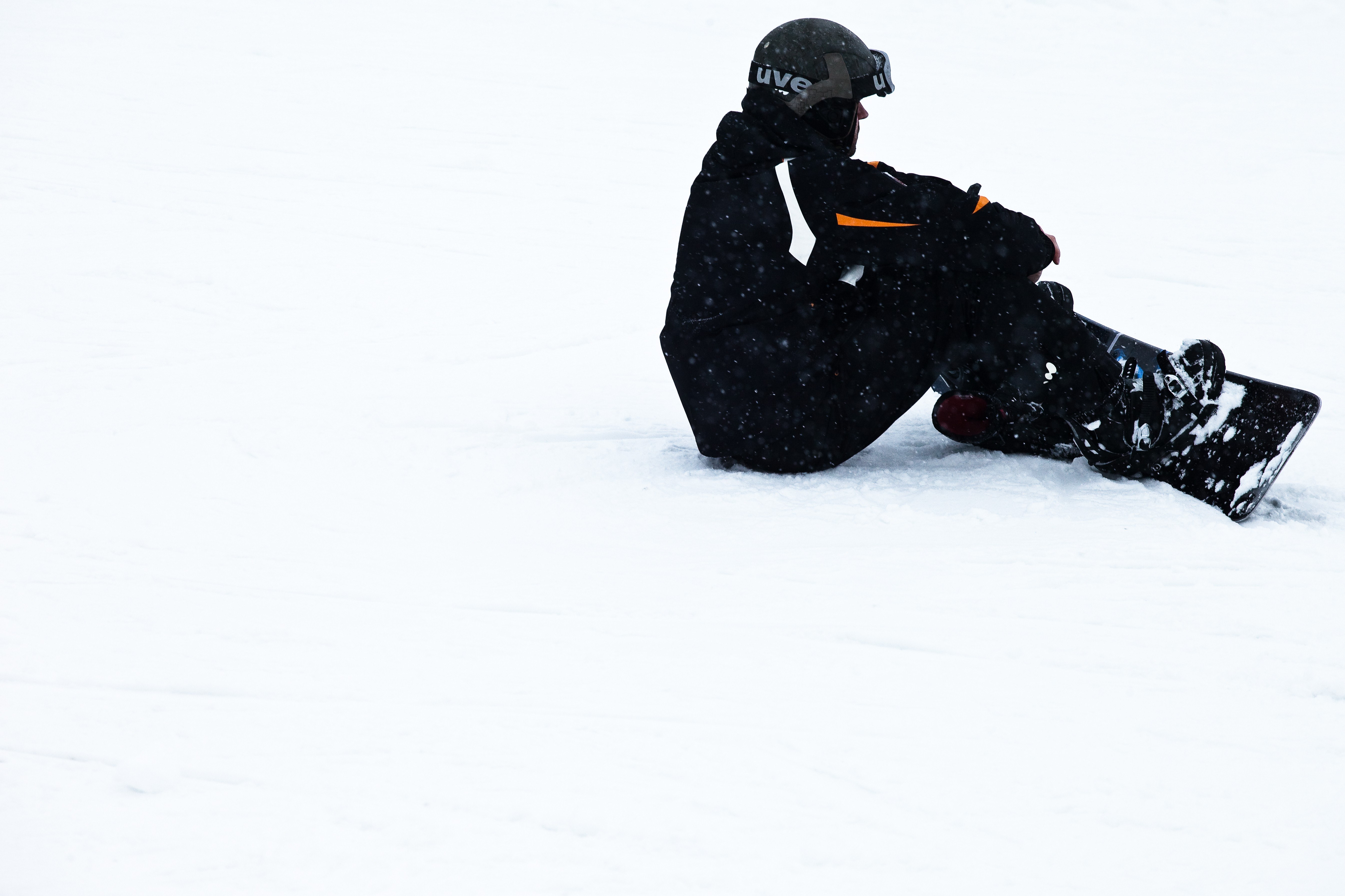 Snowboarder sitting in snow