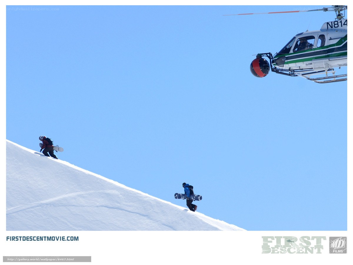 Snowboarders and helicopter on mountain