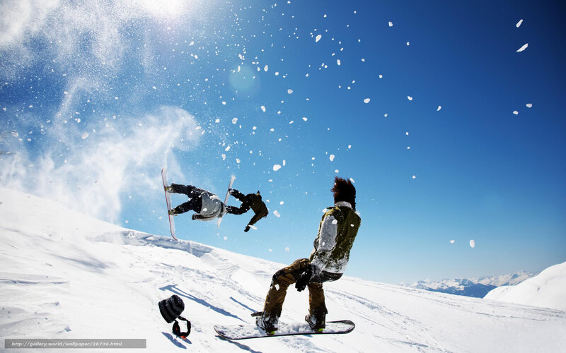 Snowboarders in action on a sunny day
