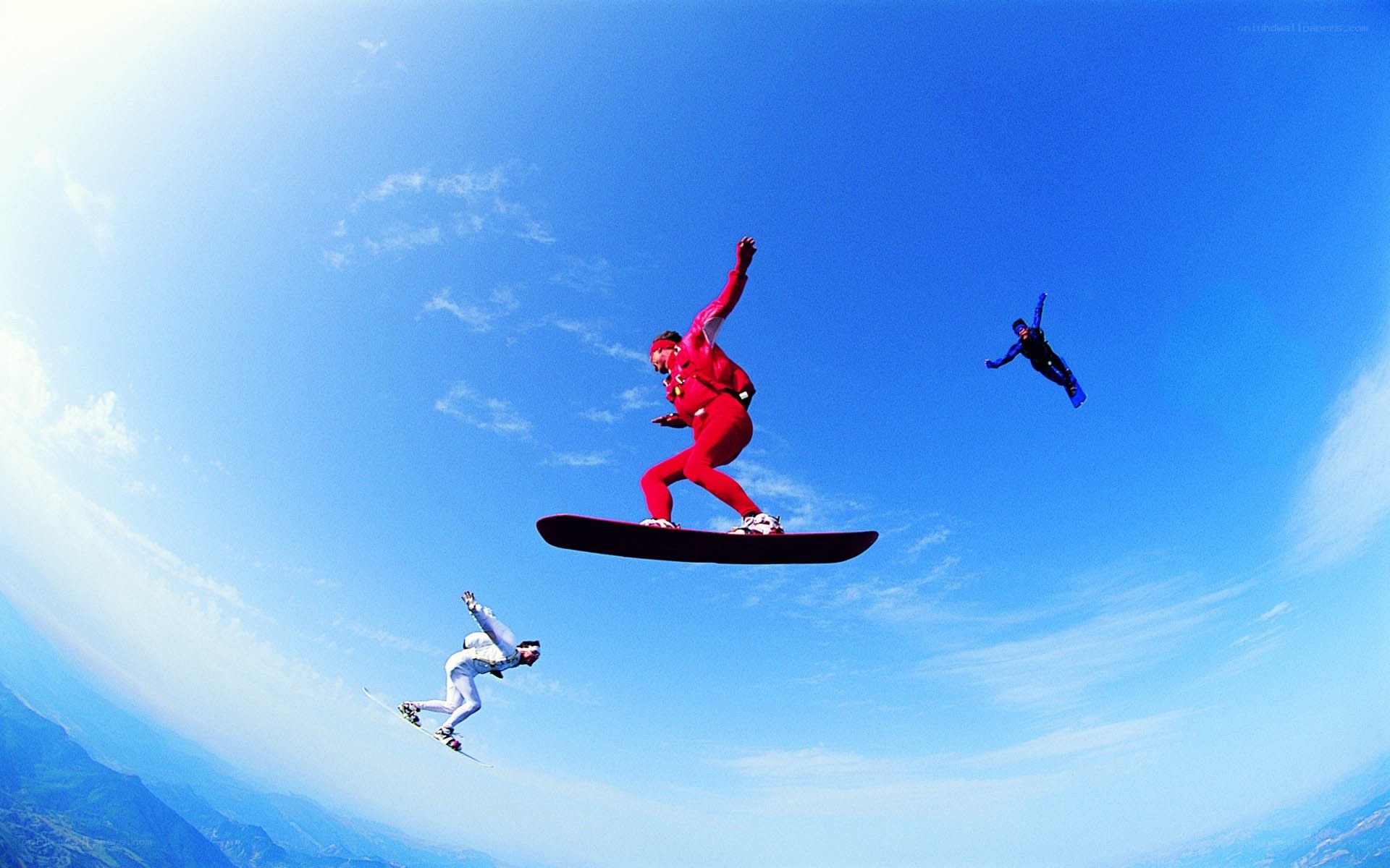 Snowboarders in mid-air