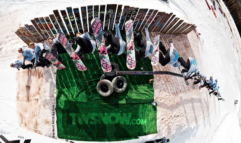 Snowboarders in mid-air trick