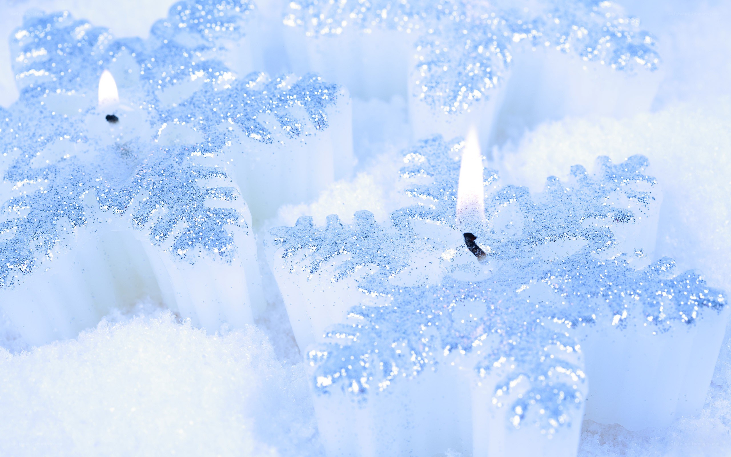 snowflake candles in snow
