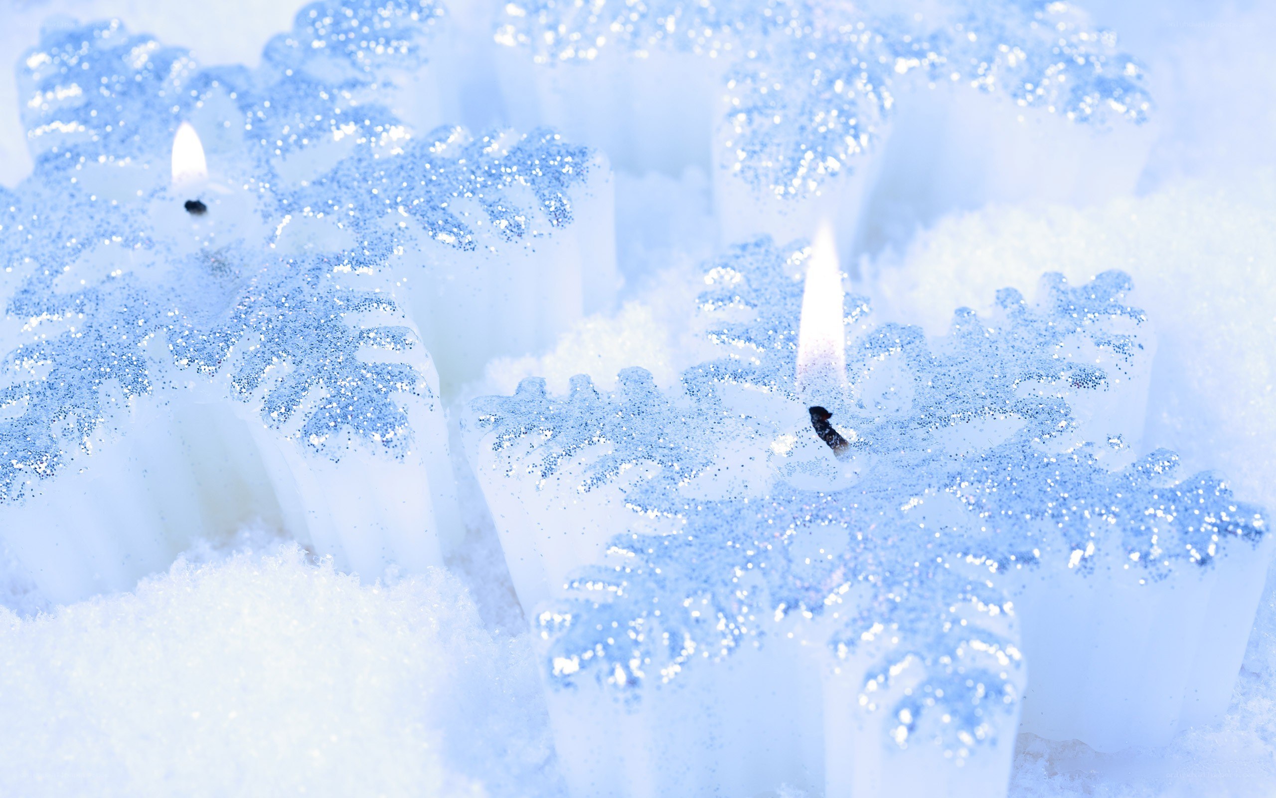 snowflake candles in snow