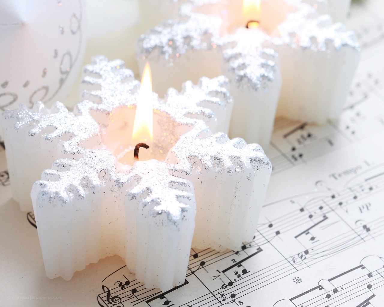 snowflake candles on sheet music