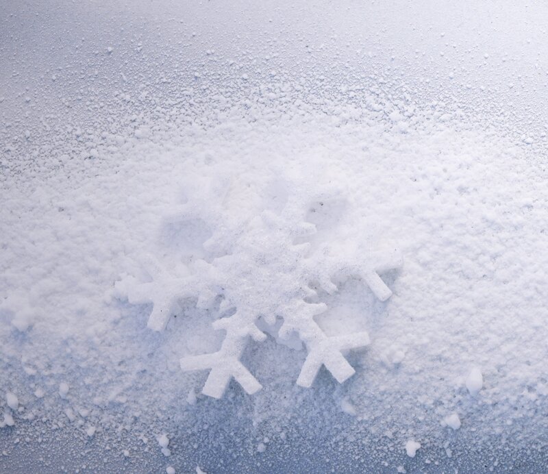 Snowflake on snowy surface