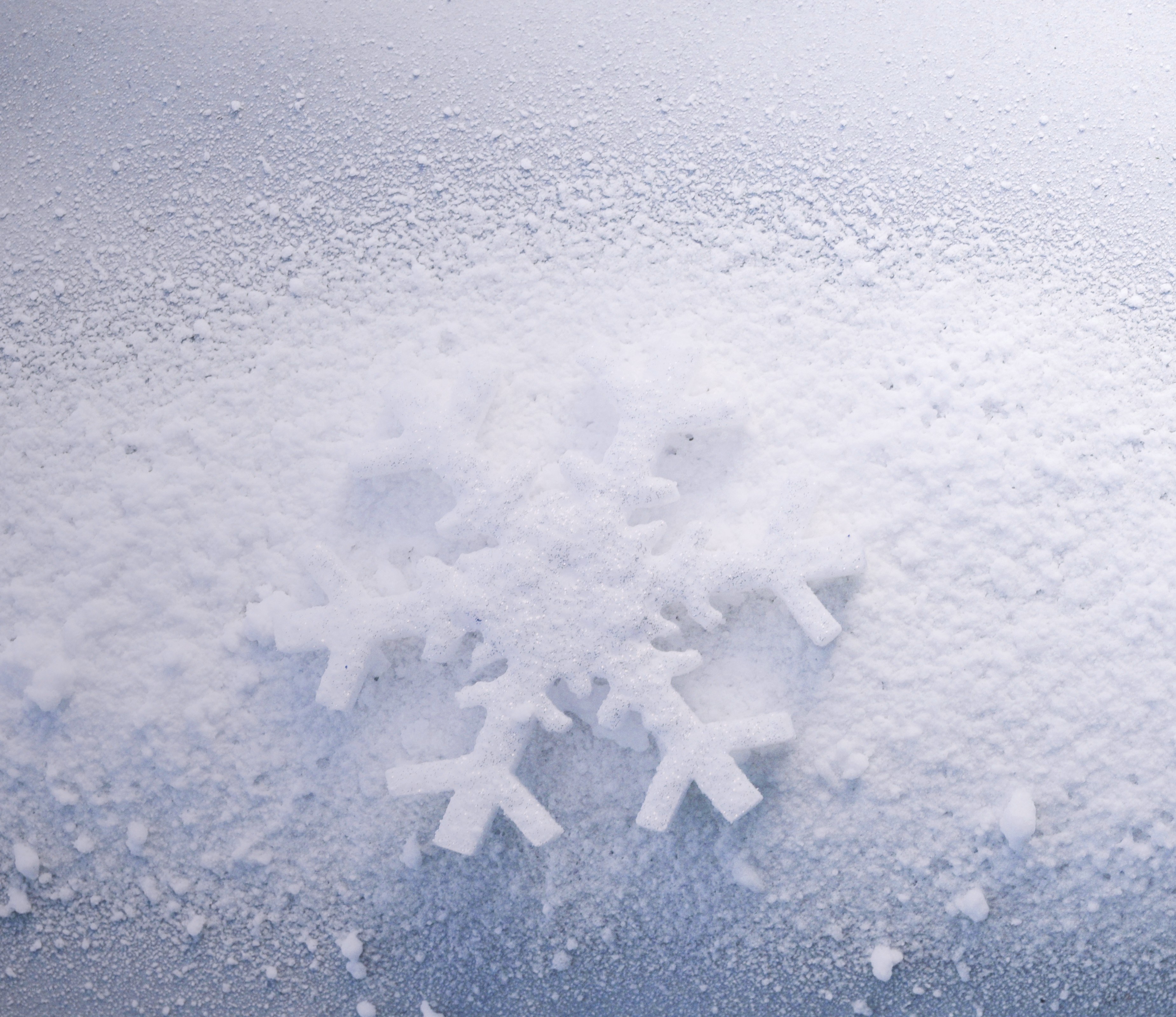 Snowflake on snowy surface