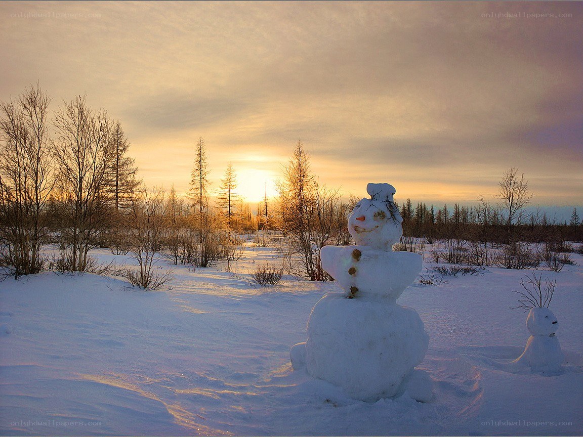 Snowman at sunset in winter