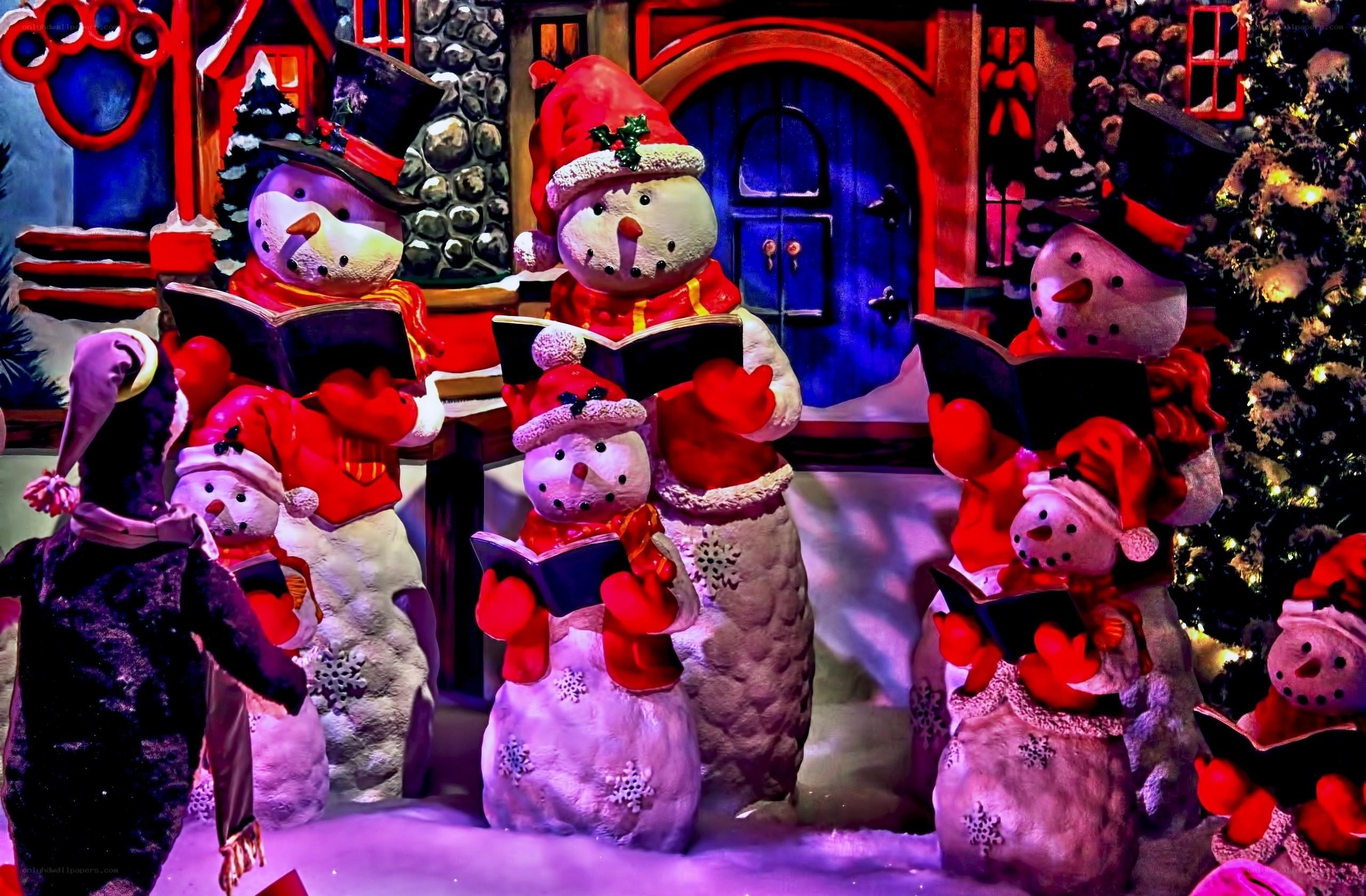 Snowman carolers in winter scene