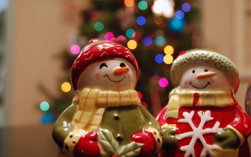 Snowman figurines near Christmas tree