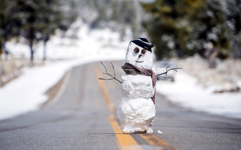 Snowman on a road