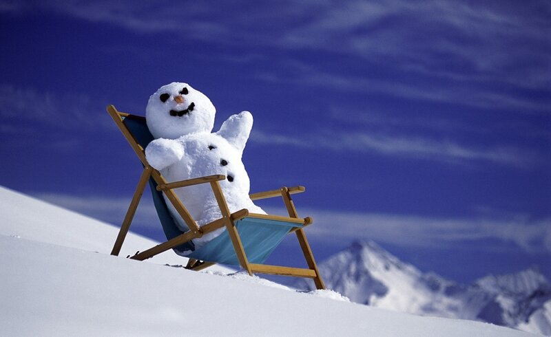 Snowman relaxing on a deck chair