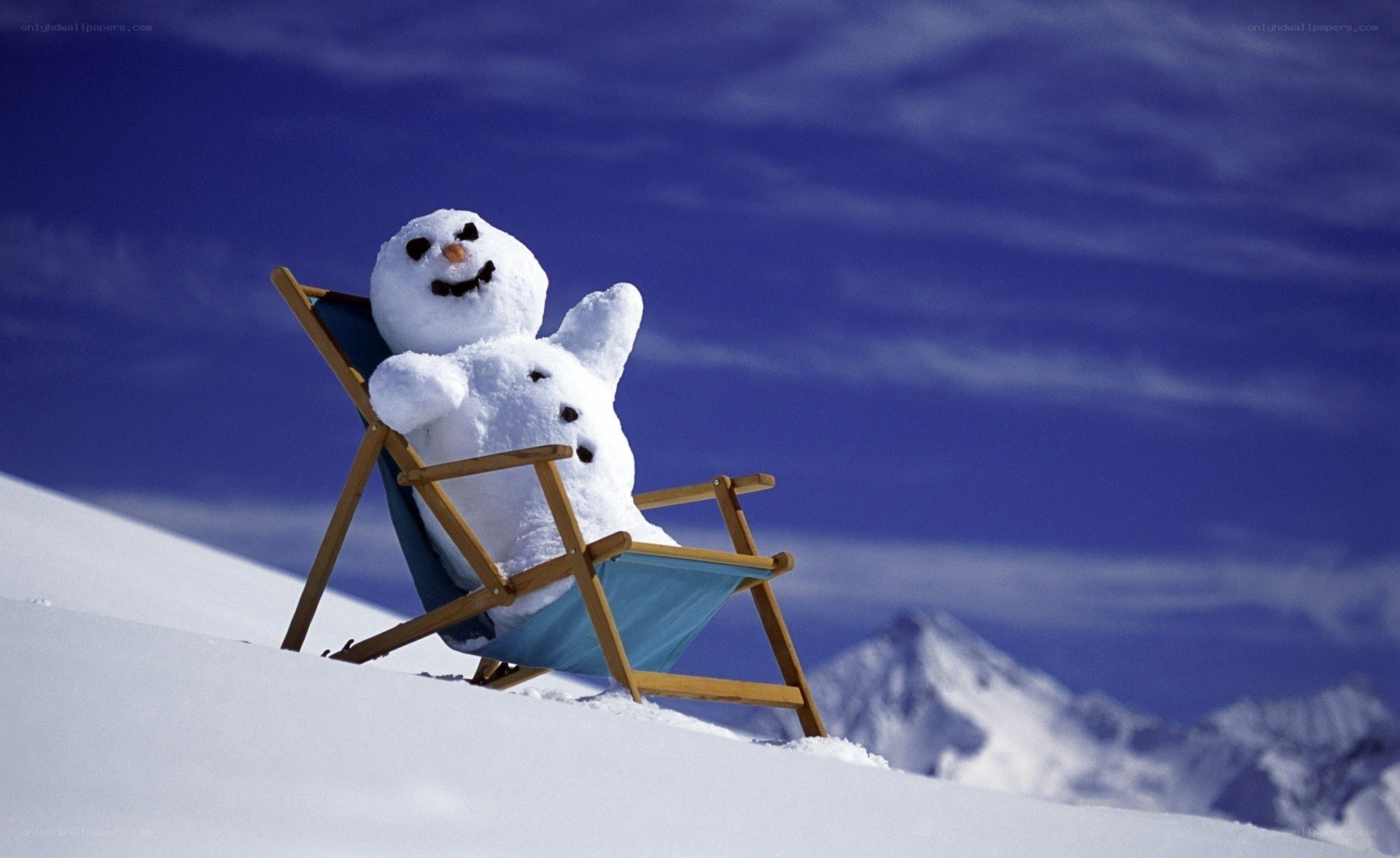 Snowman relaxing on a deck chair