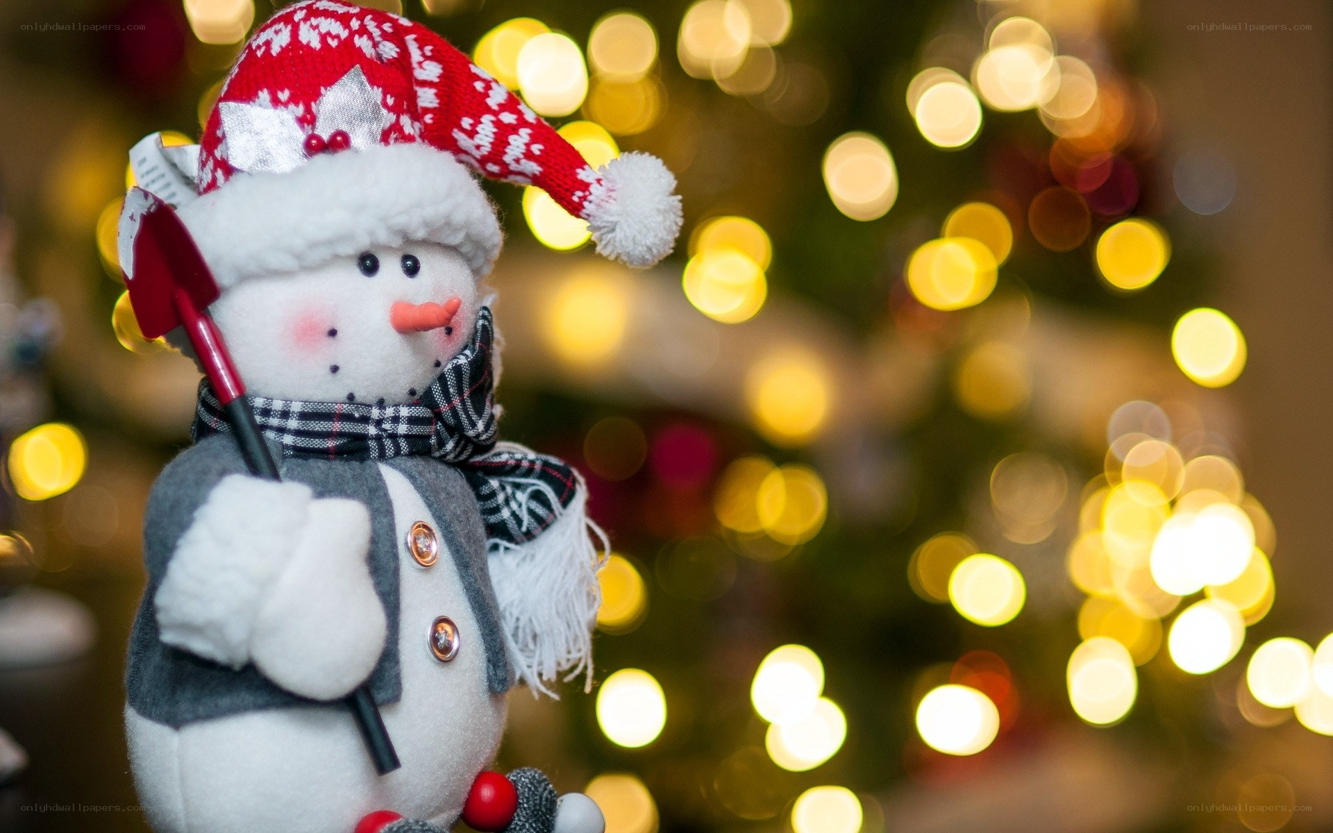 Snowman with shovel in lights