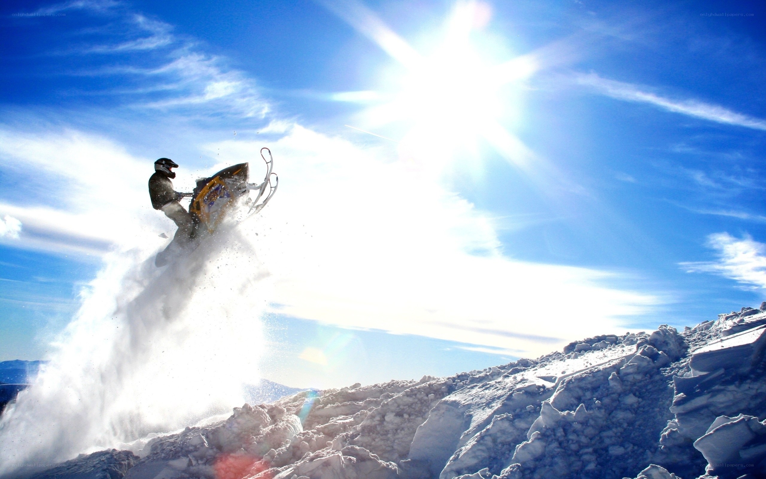 Snowmobiler in mid-air jump