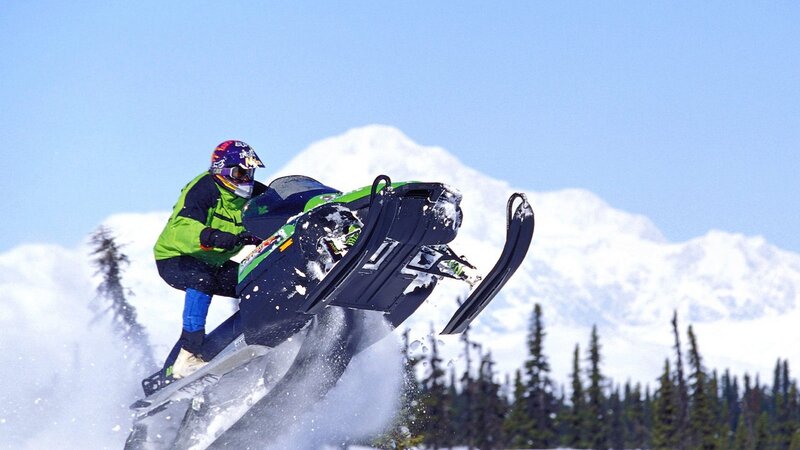 Snowmobiler performing jump