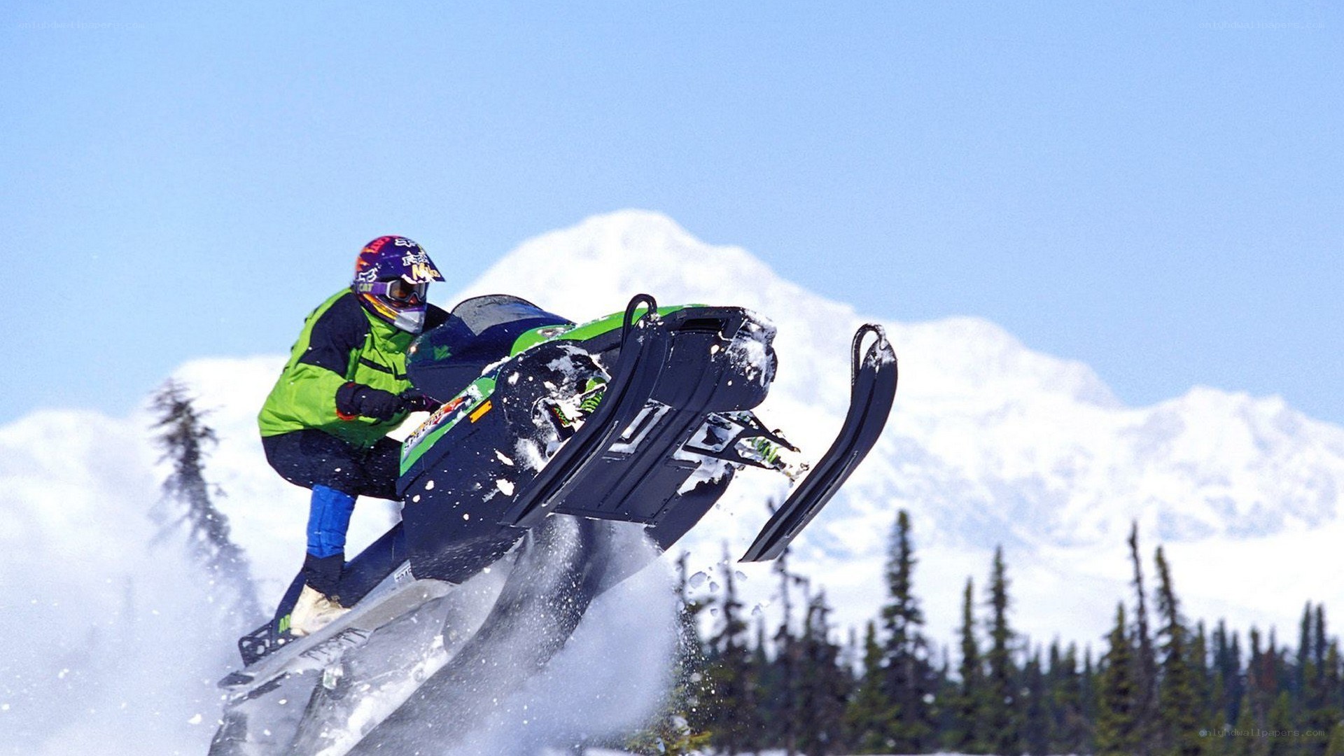 Snowmobiler performing jump