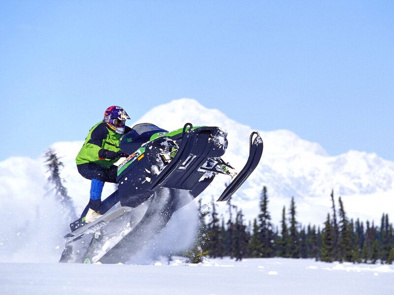 Snowmobiler performing jump