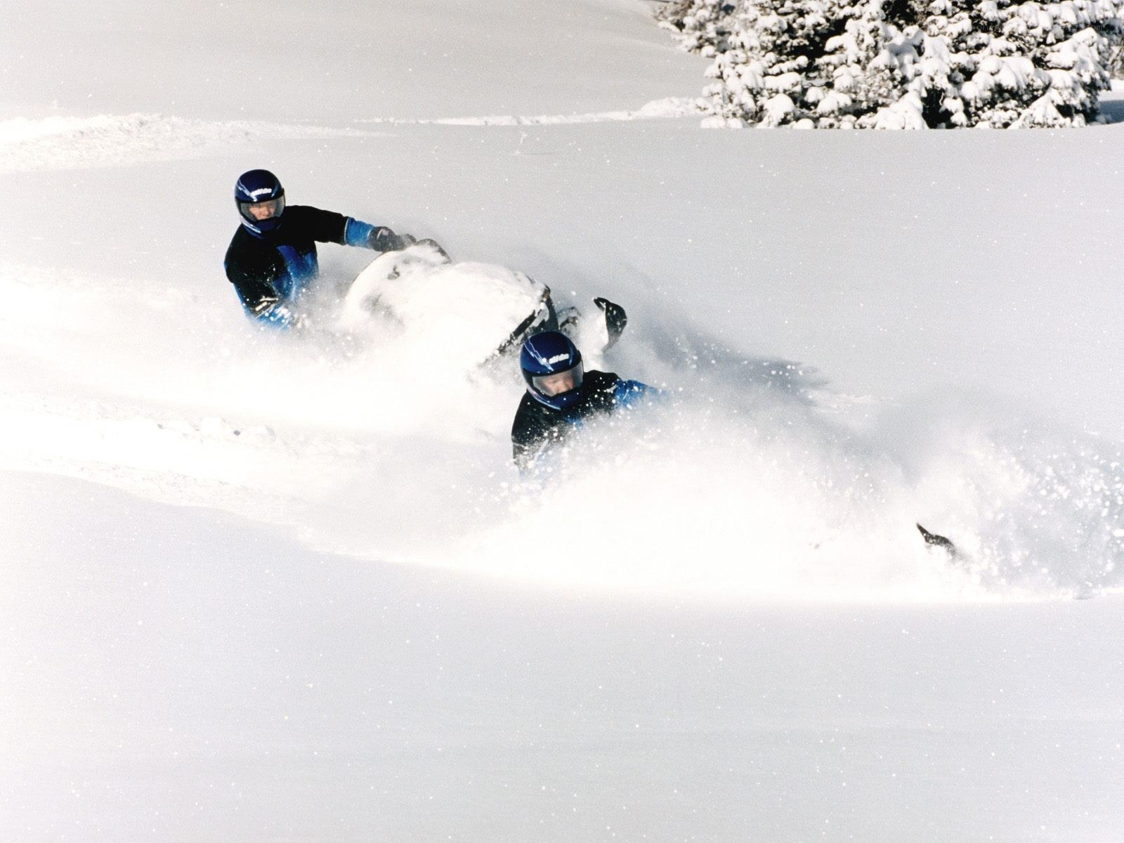 Snowmobilers in deep snow