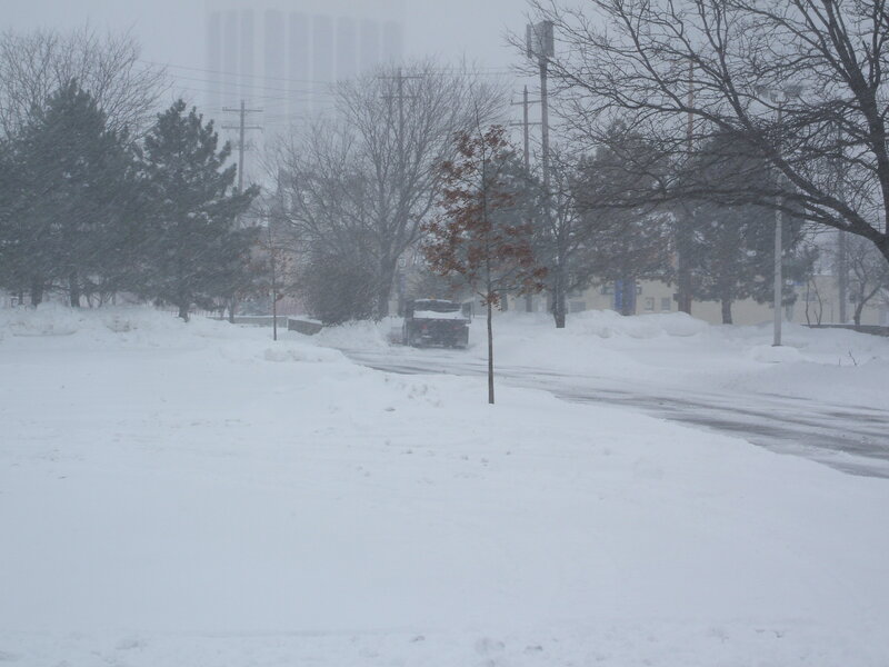 Snowplow clearing road in snowstorm