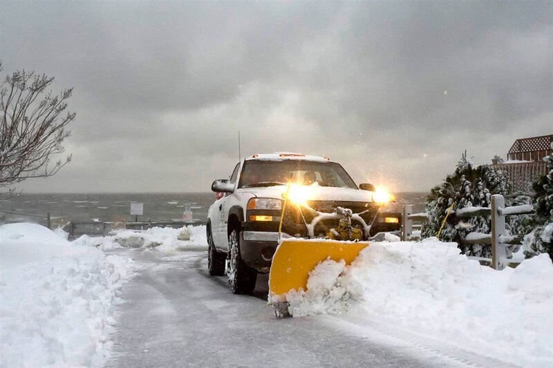 Snowplow clearing road in winter