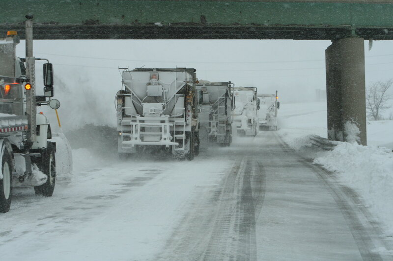 Snowplows clearing road in snowstorm