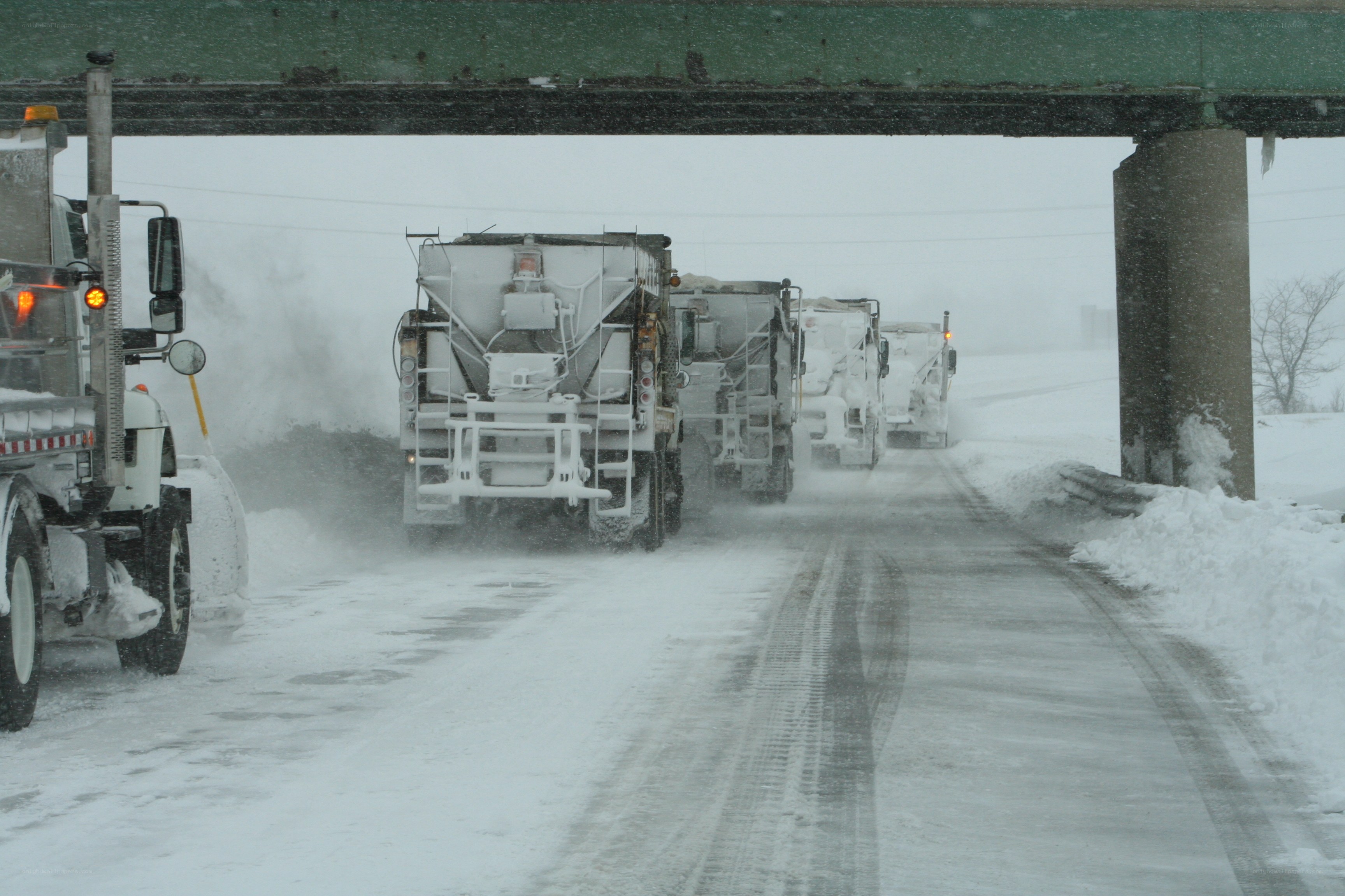Snowplows clearing road in snowstorm