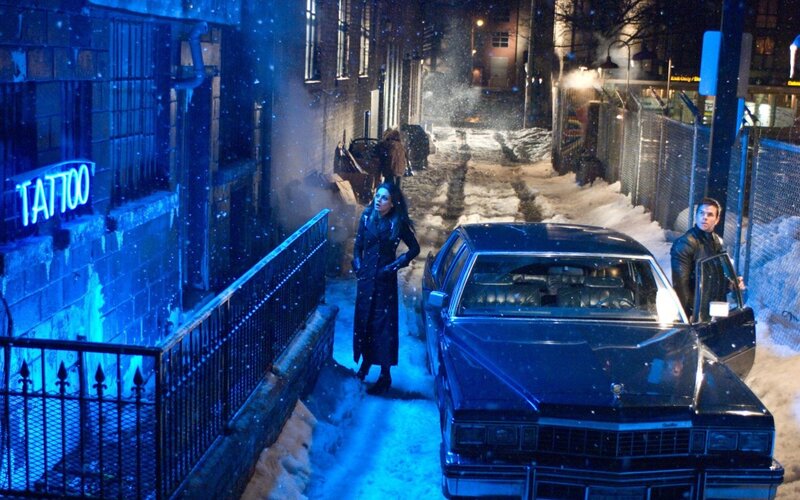 Snowy alley scene with car