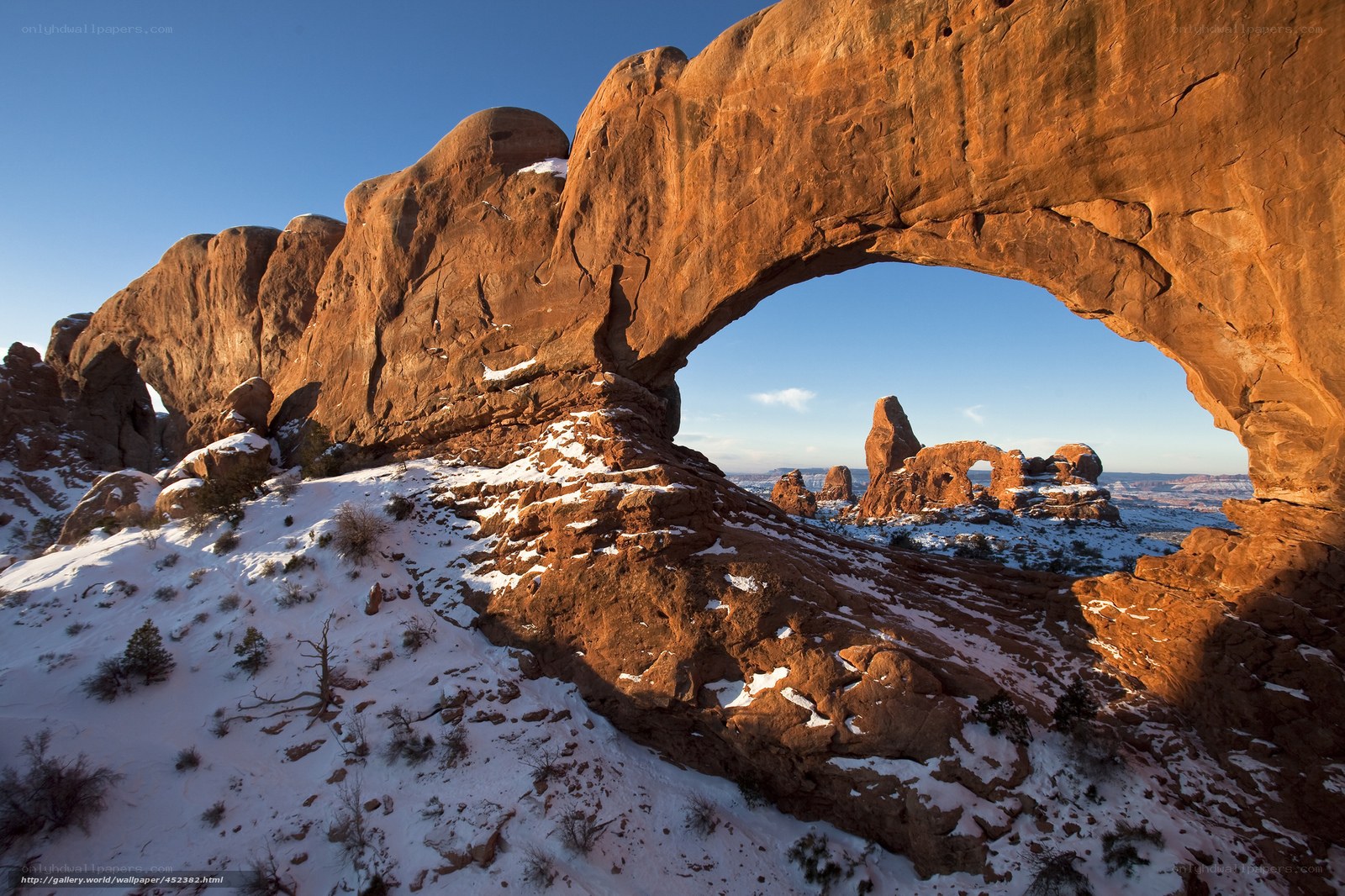 Snowy arch in desert landscape