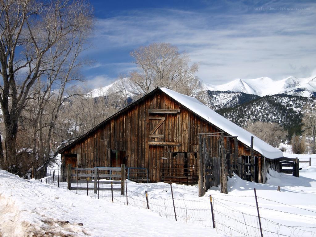 Snowy barn in mountain valley
