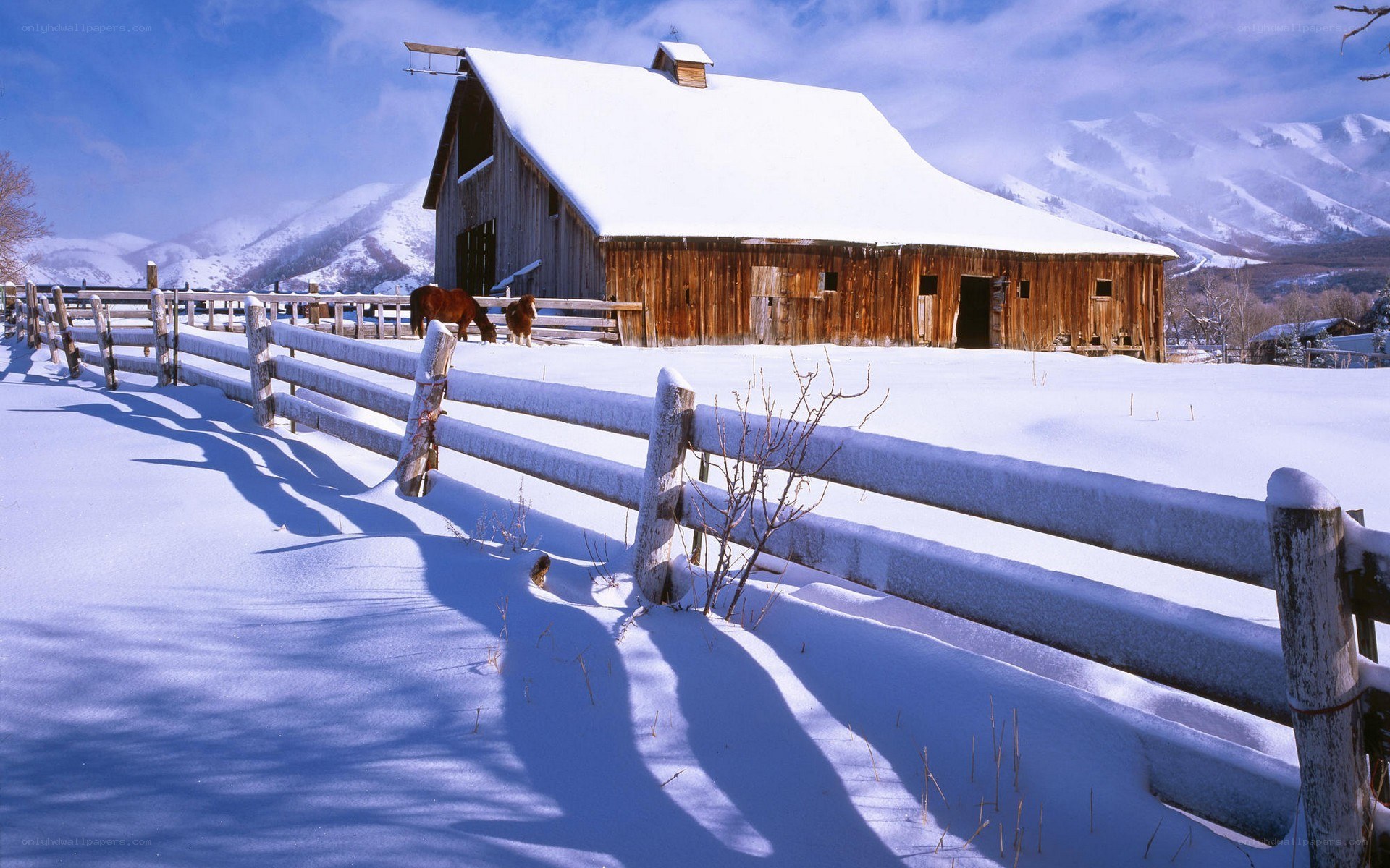 Snowy barn in mountain valley