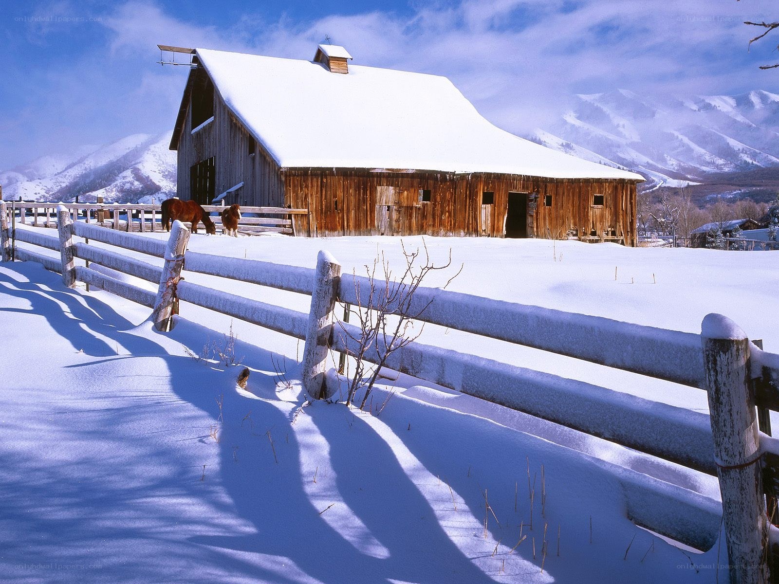 Snowy barn in mountain valley