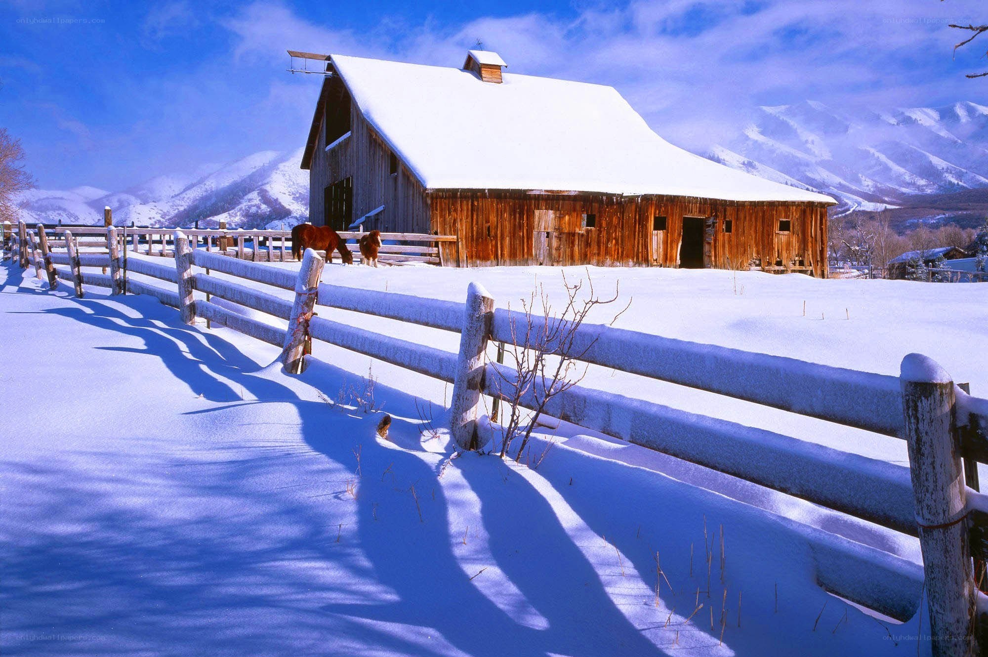 Snowy barn in mountain valley