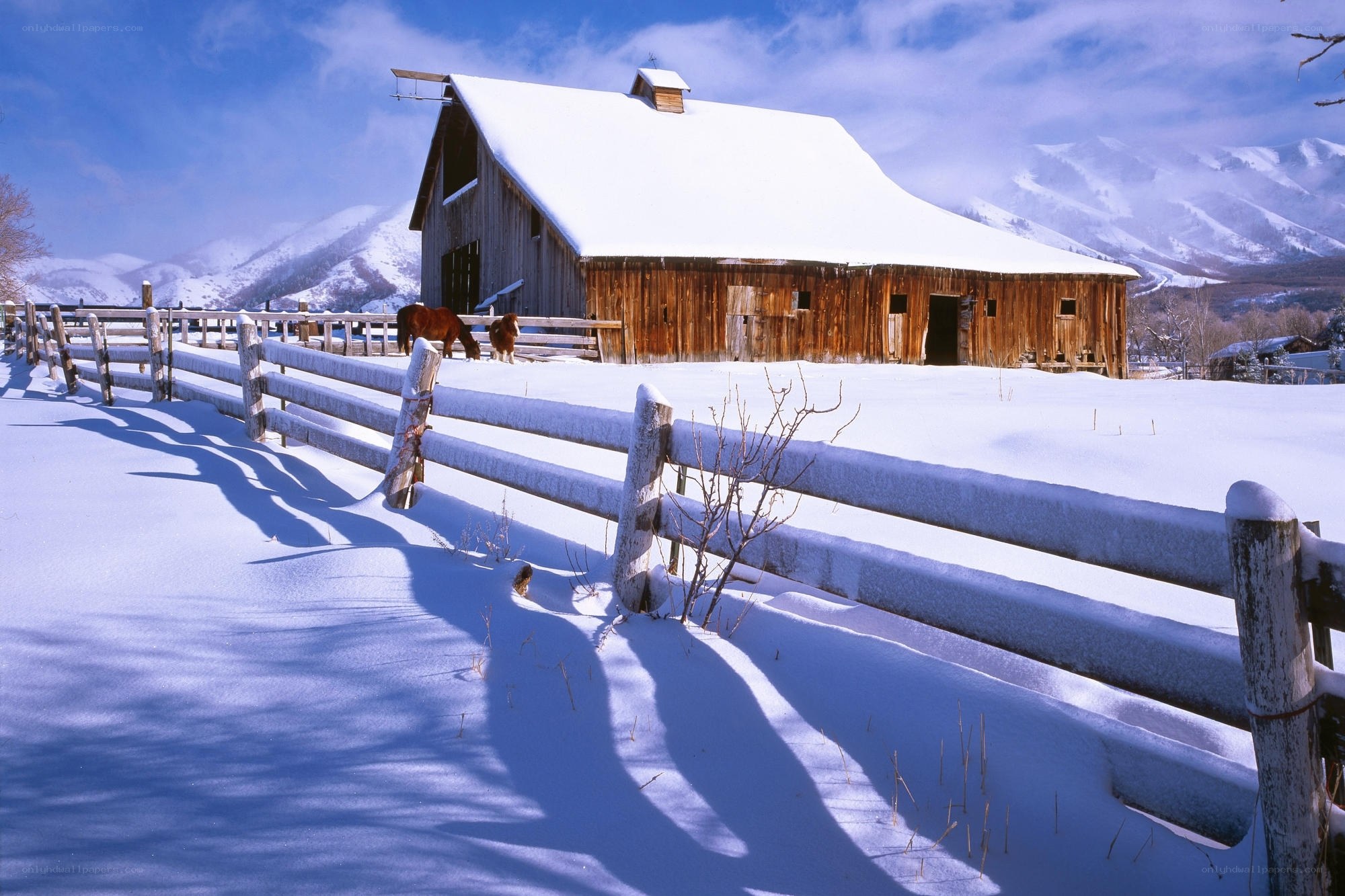 Snowy barn in mountain valley