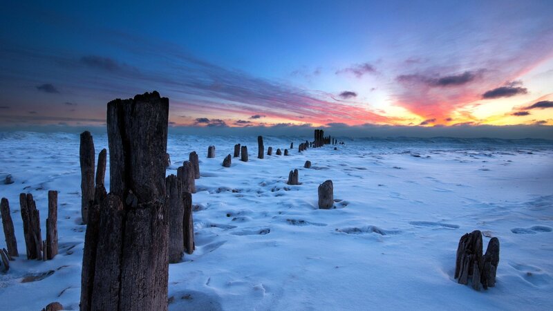 Snowy beach at sunset