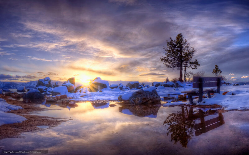 Snowy bench at sunset